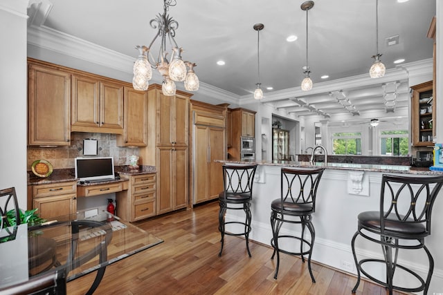 350 Saint Julian Ln, Myrtle Beach, SC 29579 - kitchen featuring a breakfast bar area, light wood-style flooring, decorative backsplash, recessed lighting, and crown molding