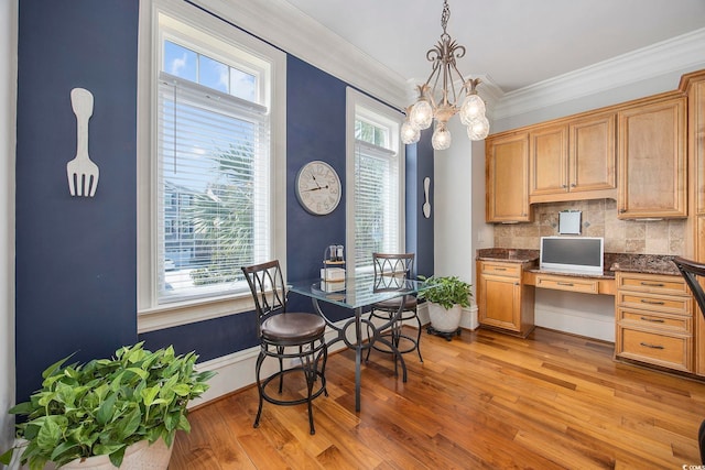350 Saint Julian Ln, Myrtle Beach, SC 29579 - dining area with light wood-style flooring, built in desk, a chandelier, plenty of natural light, and crown molding
