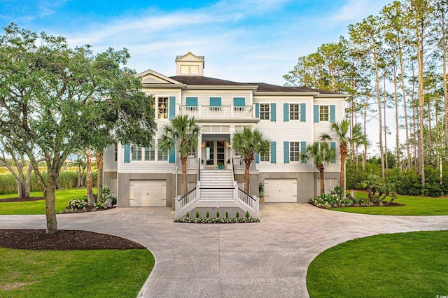 288 Tipperary Pl, Pawleys Island, SC 29585 - raised beach house with stairway, a balcony, an attached garage, and driveway
