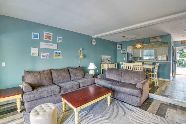 832 Villa Dr Unit 832, North Myrtle Beach, SC 29582 - living room with wood finished floors, a textured ceiling, and beam ceiling