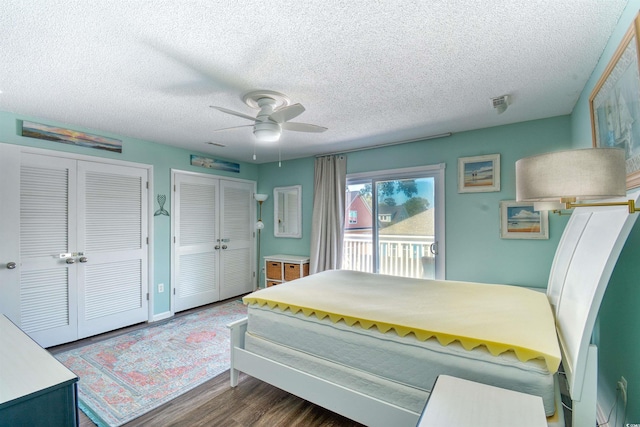 832 Villa Dr Unit 832, North Myrtle Beach, SC 29582 - bedroom featuring access to outside, a textured ceiling, dark wood-style flooring, multiple closets, and a ceiling fan