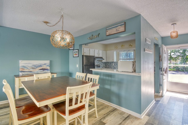 832 Villa Dr Unit 832, North Myrtle Beach, SC 29582 - dining area with a textured ceiling and light wood-style flooring