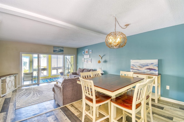 832 Villa Dr Unit 832, North Myrtle Beach, SC 29582 - dining room with light wood-style floors, a textured ceiling, and a chandelier