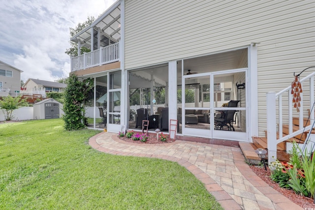 505 41st Ave S, North Myrtle Beach, SC 29582 - back of house featuring a shed, a yard, a sunroom, a patio, and a balcony