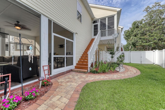 505 41st Ave S, North Myrtle Beach, SC 29582 - back of property with a sunroom, a gate, stairway, a fenced backyard, and a ceiling fan