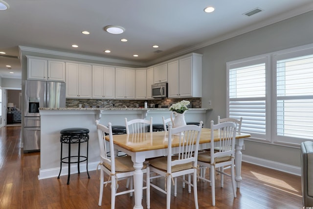 505 41st Ave S, North Myrtle Beach, SC 29582 - dining room featuring ornamental molding, dark wood-type flooring, and recessed lighting