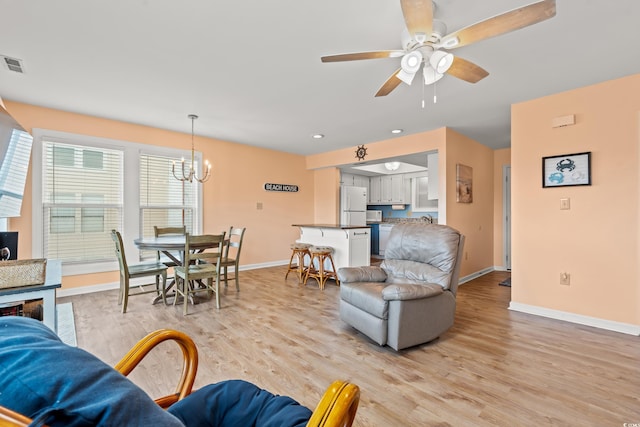 212 29th Ave N Unit 204, North Myrtle Beach, SC 29582 - living room featuring a chandelier, light wood finished floors, ceiling fan, and recessed lighting