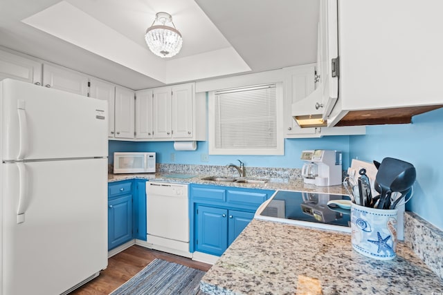 212 29th Ave N Unit 204, North Myrtle Beach, SC 29582 - kitchen with white appliances, blue cabinetry, dark wood-style floors, a tray ceiling, and white cabinetry