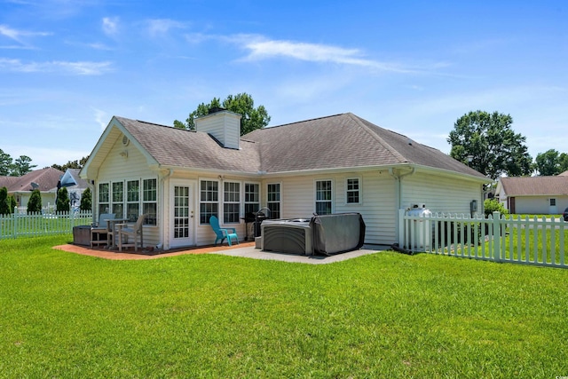483 Oakmont Dr, Myrtle Beach, SC 29579 - rear view of property featuring a hot tub, a patio, a fenced backyard, a chimney, and a shingled roof