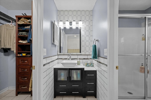 483 Oakmont Dr, Myrtle Beach, SC 29579 - full bathroom featuring a shower stall, vanity, wallpapered walls, a spacious closet, and tile patterned floors