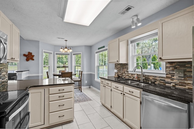 483 Oakmont Dr, Myrtle Beach, SC 29579 - kitchen featuring appliances with stainless steel finishes, a textured ceiling, decorative backsplash, a chandelier, and pendant lighting