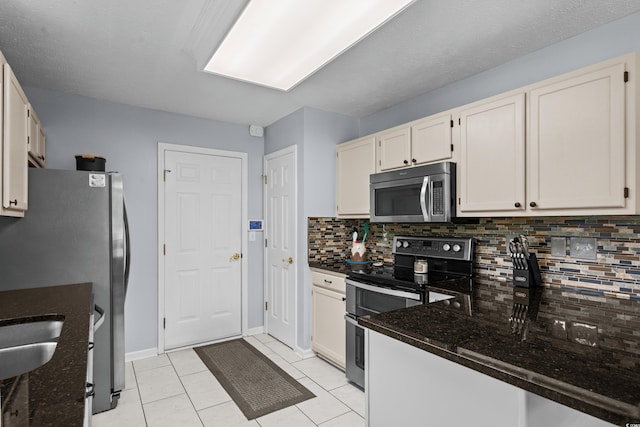 483 Oakmont Dr, Myrtle Beach, SC 29579 - kitchen with stainless steel appliances, decorative backsplash, dark stone counters, and light tile patterned floors