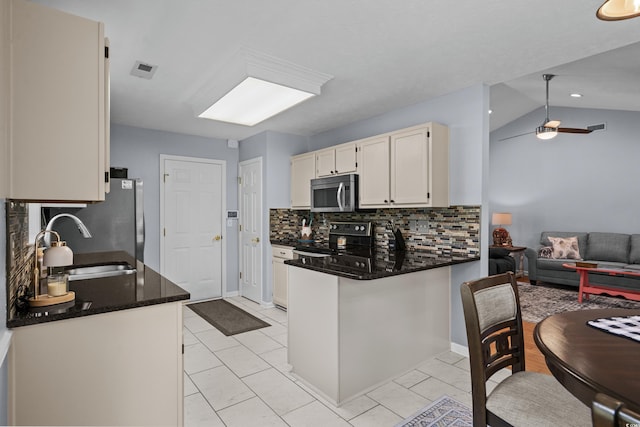 483 Oakmont Dr, Myrtle Beach, SC 29579 - kitchen with stainless steel appliances, decorative backsplash, a peninsula, white cabinets, and open floor plan