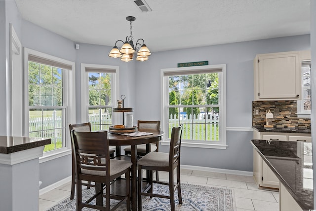 483 Oakmont Dr, Myrtle Beach, SC 29579 - dining space featuring a chandelier, light tile patterned floors, and a textured ceiling