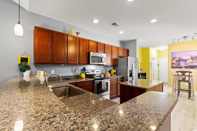1590 Palmina Loop Unit A, Myrtle Beach, SC 29588 - kitchen featuring stainless steel appliances, a center island, dark stone countertops, pendant lighting, and recessed lighting