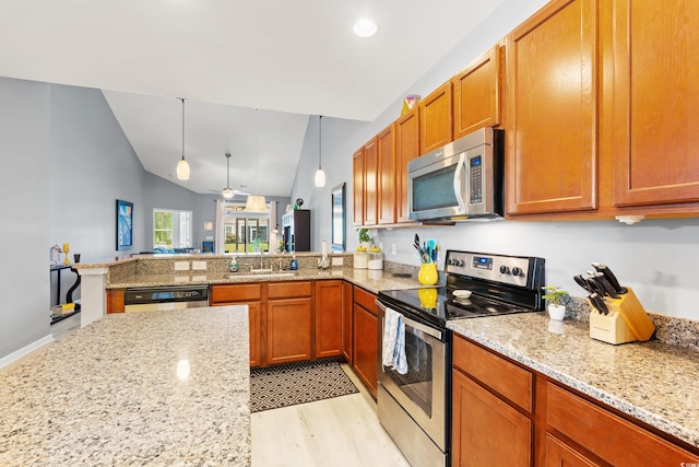 1590 Palmina Loop Unit A, Myrtle Beach, SC 29588 - kitchen featuring stainless steel appliances, light wood finished floors, a peninsula, light stone countertops, and vaulted ceiling