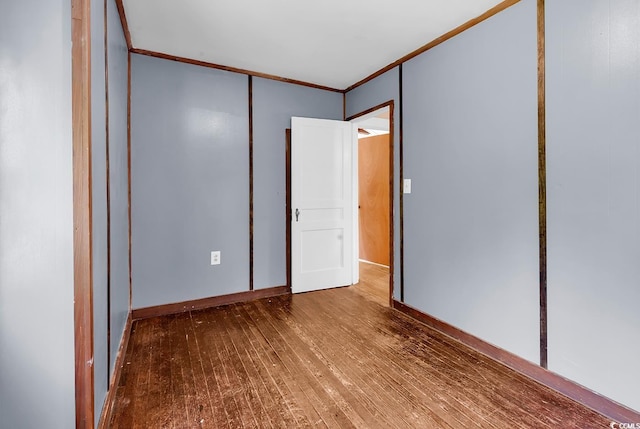203 Lakeland Dr, Conway, SC 29526 - unfurnished bedroom featuring wood finished floors, crown molding, and a closet