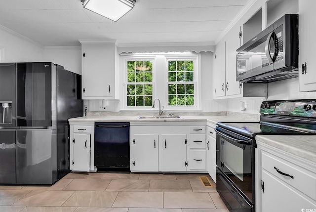 203 Lakeland Dr, Conway, SC 29526 - kitchen with black appliances, crown molding, light countertops, white cabinetry, and light tile patterned floors