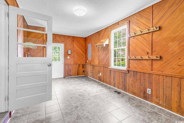 203 Lakeland Dr, Conway, SC 29526 - empty room featuring wood walls, tile patterned floors, and a textured ceiling
