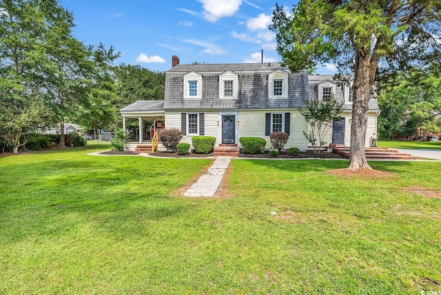 203 Lakeland Dr, Conway, SC 29526 - colonial inspired home featuring a chimney, a front yard, roof with shingles, and a porch