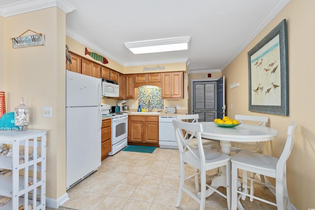 5000 N Ocean Blvd Unit E-2, North Myrtle Beach, SC 29582 - kitchen featuring white appliances, ornamental molding, light countertops, light tile patterned floors, and brown cabinets