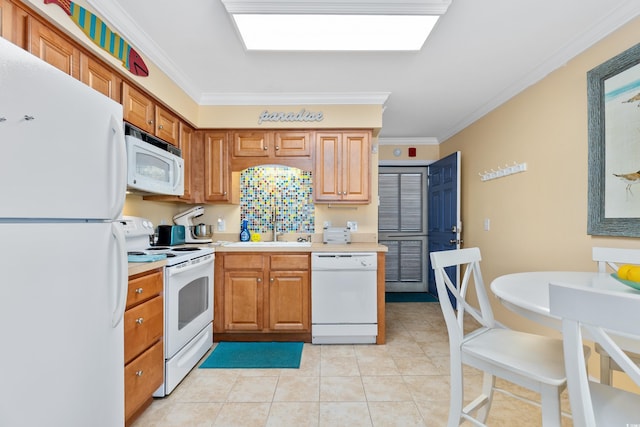5000 N Ocean Blvd Unit E-2, North Myrtle Beach, SC 29582 - kitchen with white appliances, crown molding, light tile patterned floors, light countertops, and brown cabinets