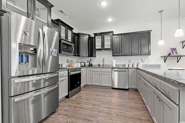 1428 Lanterns Rest Rd Unit 1428, Myrtle Beach, SC 29579 - kitchen featuring stainless steel appliances, ornamental molding, decorative backsplash, glass insert cabinets, and light stone countertops