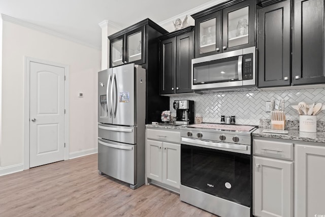 1428 Lanterns Rest Rd Unit 1428, Myrtle Beach, SC 29579 - kitchen with stainless steel appliances, ornamental molding, backsplash, dark cabinets, and light wood-style flooring