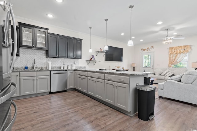 1428 Lanterns Rest Rd Unit 1428, Myrtle Beach, SC 29579 - kitchen featuring appliances with stainless steel finishes, open floor plan, a peninsula, tasteful backsplash, and light stone counters