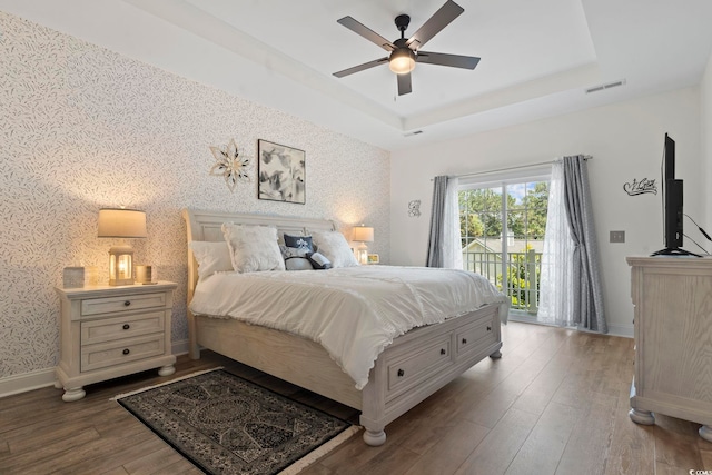 1428 Lanterns Rest Rd Unit 1428, Myrtle Beach, SC 29579 - bedroom featuring wallpapered walls, access to outside, a tray ceiling, wood finished floors, and a ceiling fan