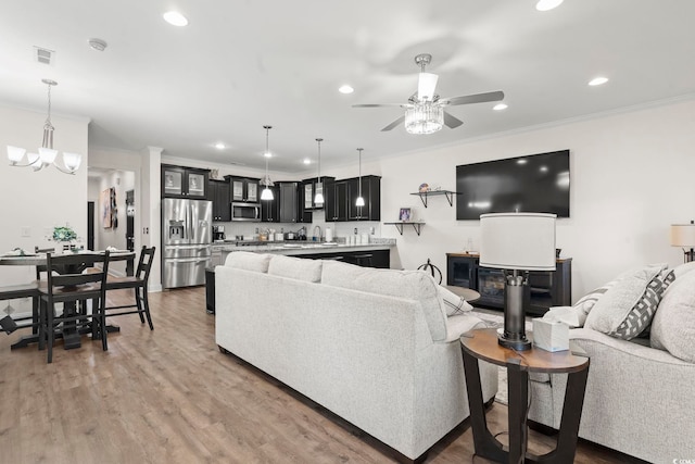 1428 Lanterns Rest Rd Unit 1428, Myrtle Beach, SC 29579 - living room featuring ornamental molding, a ceiling fan, recessed lighting, light wood-type flooring, and a chandelier