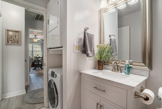 6570 Pebble Beach Cres, Myrtle Beach, SC 29588 - bathroom featuring washer / clothes dryer, vanity, wood finished floors, and ceiling fan