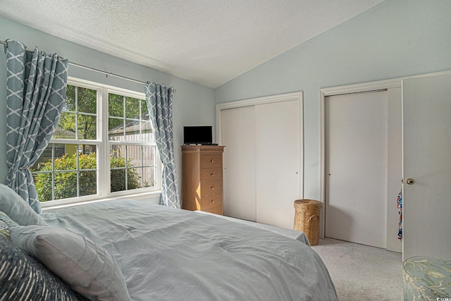6570 Pebble Beach Cres, Myrtle Beach, SC 29588 - carpeted bedroom featuring vaulted ceiling, two closets, and a textured ceiling
