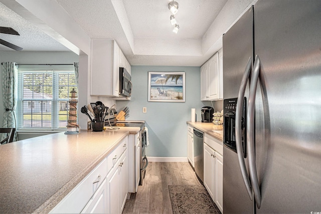 6570 Pebble Beach Cres, Myrtle Beach, SC 29588 - kitchen with appliances with stainless steel finishes, white cabinets, a textured ceiling, light wood-type flooring, and light countertops