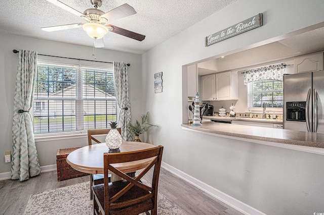 6570 Pebble Beach Cres, Myrtle Beach, SC 29588 - dining area featuring light wood finished floors, a textured ceiling, and a ceiling fan