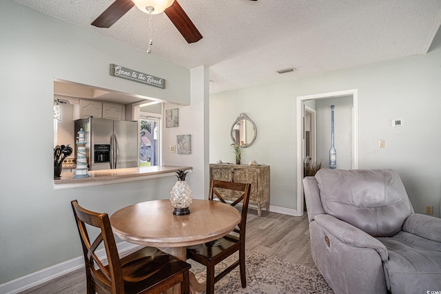 6570 Pebble Beach Cres, Myrtle Beach, SC 29588 - dining area with a textured ceiling, light wood finished floors, and ceiling fan