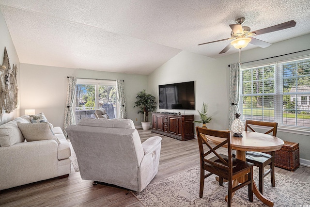 6570 Pebble Beach Cres, Myrtle Beach, SC 29588 - living room featuring a textured ceiling, lofted ceiling, ceiling fan, and light wood-style flooring