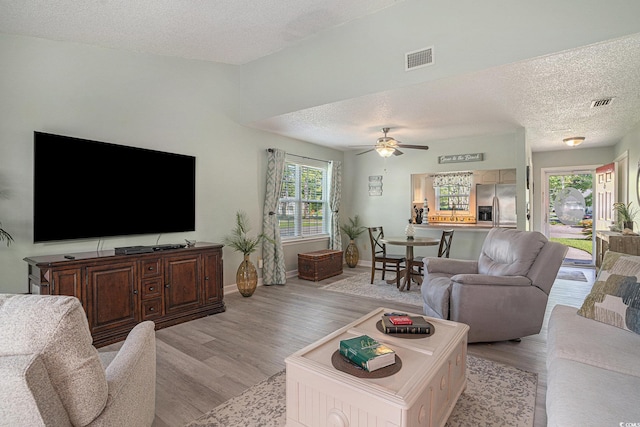 6570 Pebble Beach Cres, Myrtle Beach, SC 29588 - living room with a textured ceiling, light wood-style flooring, and a ceiling fan