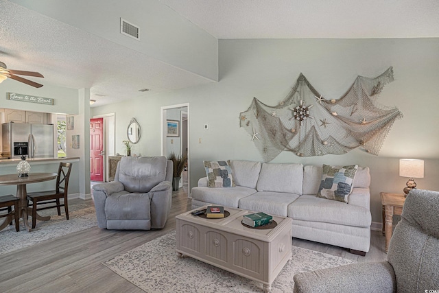 6570 Pebble Beach Cres, Myrtle Beach, SC 29588 - living area featuring light wood-type flooring, a ceiling fan, and a textured ceiling