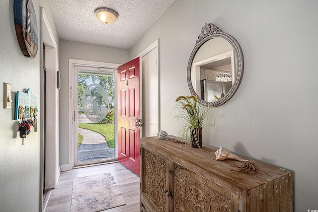 6570 Pebble Beach Cres, Myrtle Beach, SC 29588 - foyer entrance featuring light wood-style flooring and a textured ceiling