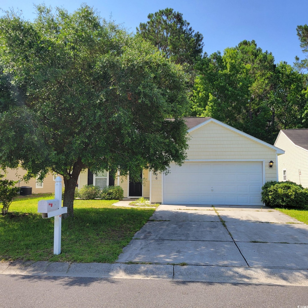 396 Bellegrove Dr, Myrtle Beach, SC 29579 - view of property hidden behind natural elements with concrete driveway, a front yard, and a garage