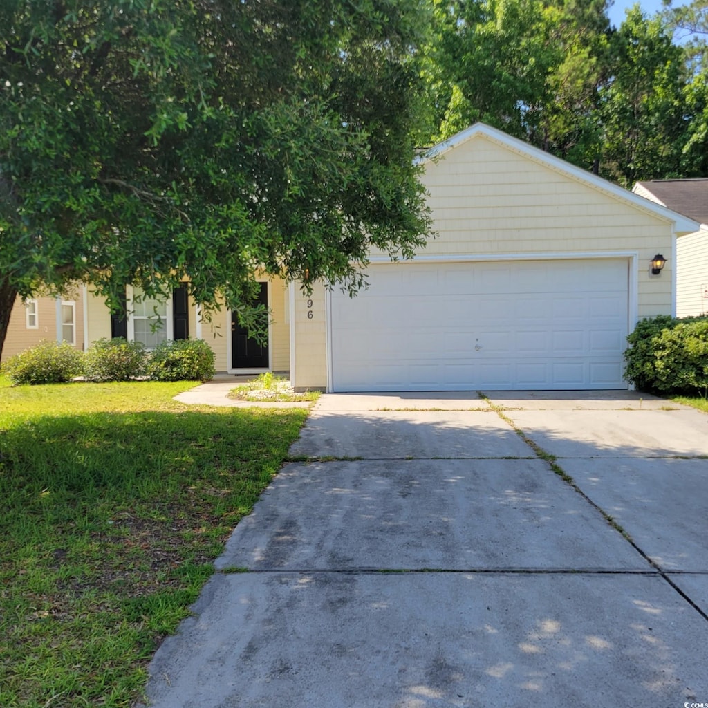 396 Bellegrove Dr, Myrtle Beach, SC 29579 - view of front of house with concrete driveway, an attached garage, and a front lawn
