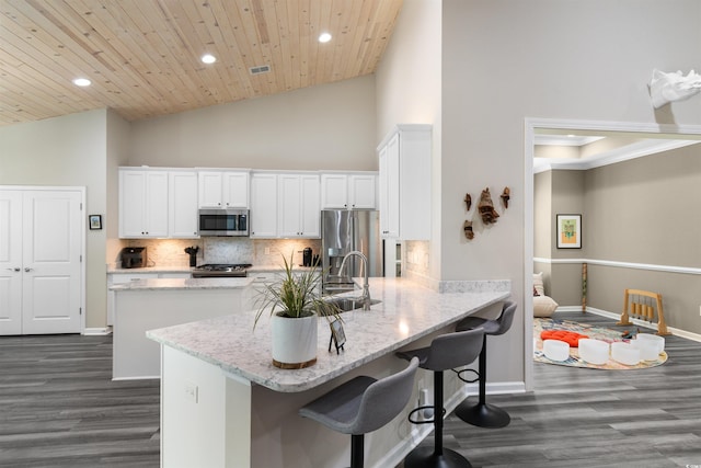 3647 Diamond Stars Way, Little River, SC 29566 - kitchen with stainless steel appliances, recessed lighting, a peninsula, white cabinets, and backsplash