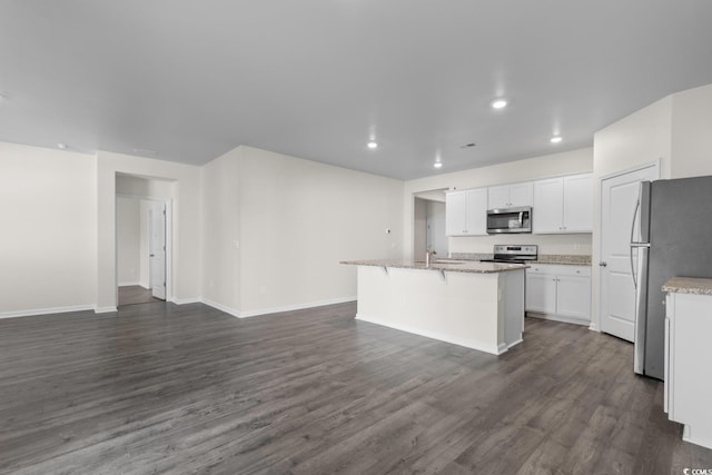 1128 Sennema Cir, Myrtle Beach, SC 29588 - kitchen with stainless steel appliances, open floor plan, white cabinets, an island with sink, and dark wood-style flooring