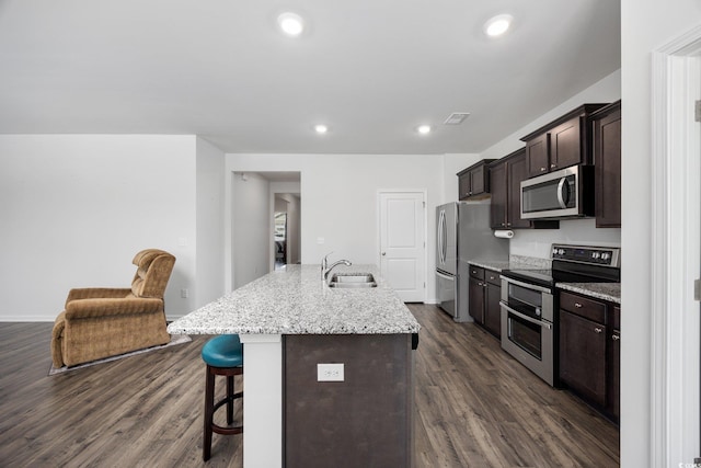 305 Forestbrook Cove Cir, Myrtle Beach, SC 29588 - kitchen featuring appliances with stainless steel finishes, a breakfast bar area, dark wood-type flooring, dark brown cabinetry, and recessed lighting