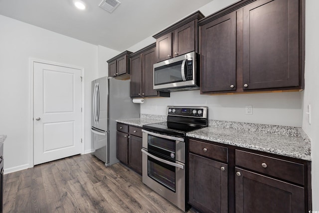 305 Forestbrook Cove Cir, Myrtle Beach, SC 29588 - kitchen with stainless steel appliances, dark brown cabinetry, dark wood-style flooring, and light stone counters