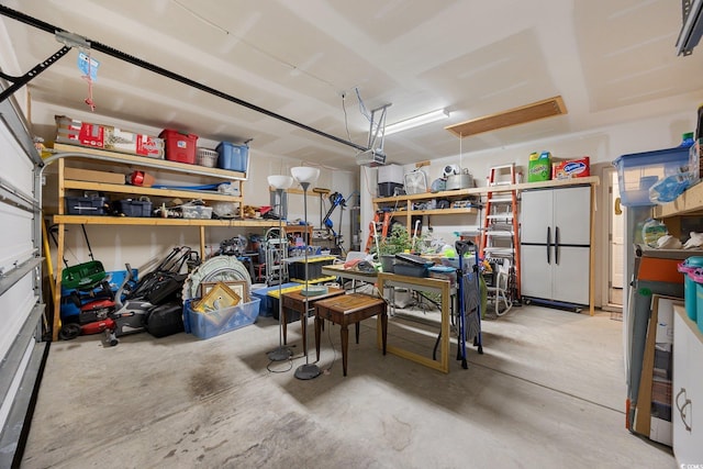 305 Forestbrook Cove Cir, Myrtle Beach, SC 29588 - garage featuring freestanding refrigerator and a garage door opener