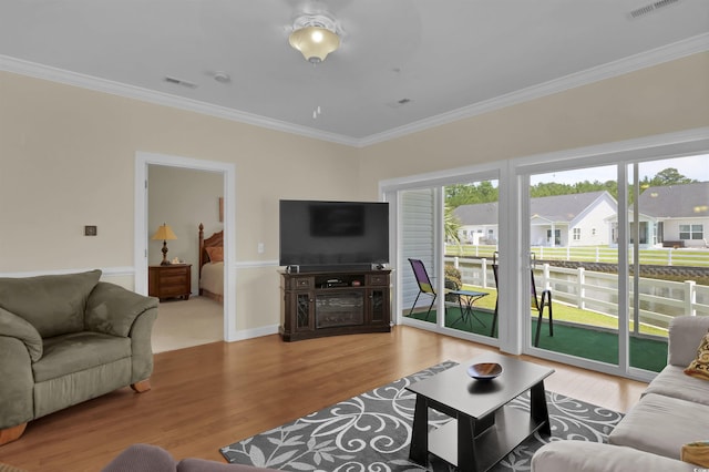 8855 Radcliff Dr NW Unit 50B, Calabash, NC 28467 - living area featuring crown molding, wood finished floors, healthy amount of natural light, and a residential view