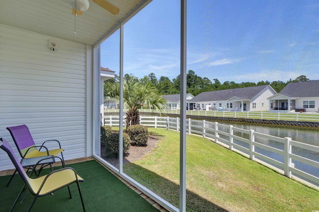 8855 Radcliff Dr NW Unit 50B, Calabash, NC 28467 - sunroom featuring a water view, ceiling fan, and a residential view