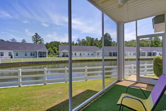 8855 Radcliff Dr NW Unit 50B, Calabash, NC 28467 - unfurnished sunroom featuring a water view, a ceiling fan, and a residential view